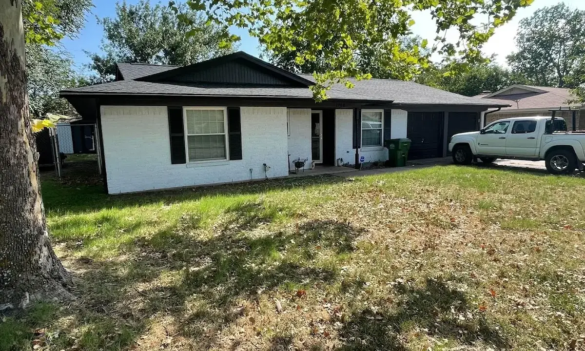 Professional roofing crew working on a residential roof in Angier